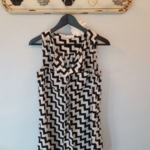 Skies are blue black and cream blouse